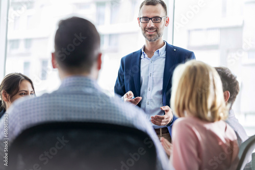 Businessman leading meeting in office