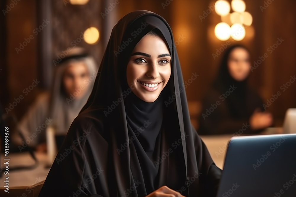 Portrait of Arabic woman in Abaya working on laptop at office. Portrait of Arabic woman in Abaya working on laptop at office.