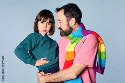 portrait of divorced lgbt father with his daughter in studio on isolated background. happy family relationship