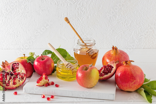 Rosh hashanah jewish New Year holiday concept. Traditional symbol. Apples, honey, pomegranate.