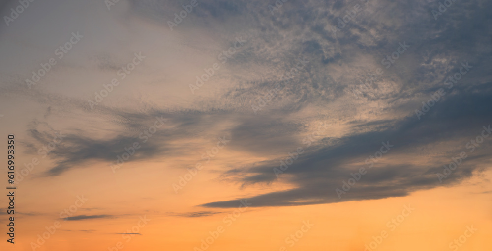 sky background with gray clouds and orange afterglow at sunset