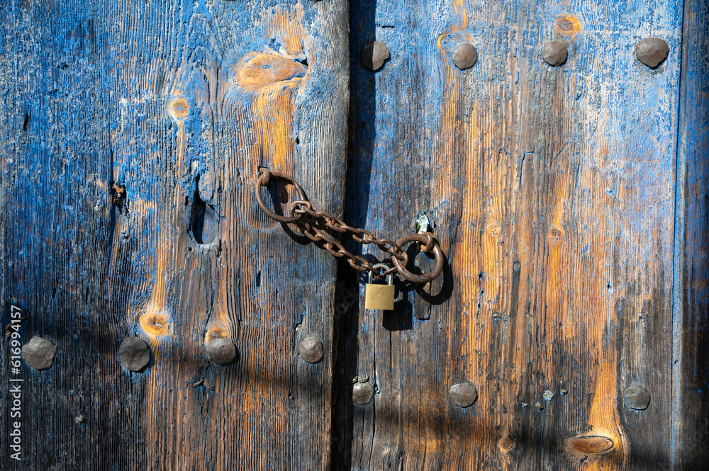 Wooden door of an old stone house in the traditional village of Monodendri in Zagori, Greece Wooden door of an old stone house in the traditional village of Monodendri in Zagori, Greece