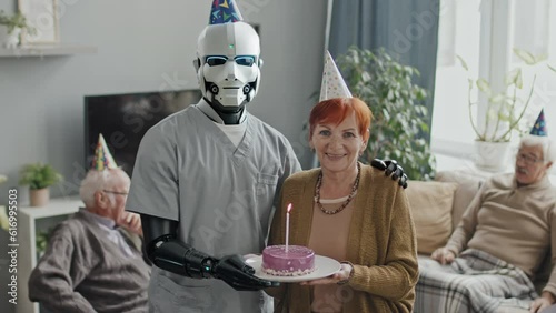 AI generated shot of cheerful senior woman celebrating birthday standing with humanoid robot nurse holding plate with cake looking at camera