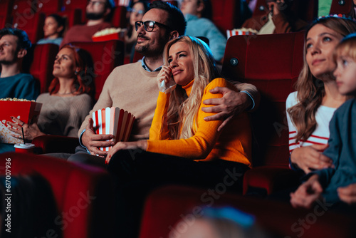 Couple watching sad movie in cinema.