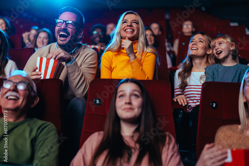 Joyful couple watching movie in theater.