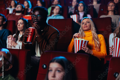 African American man watching movie in theater.