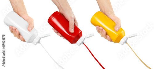 Photography Set of hands squeezing mustard, ketchup and mayonnaise out of plastic bottles, c