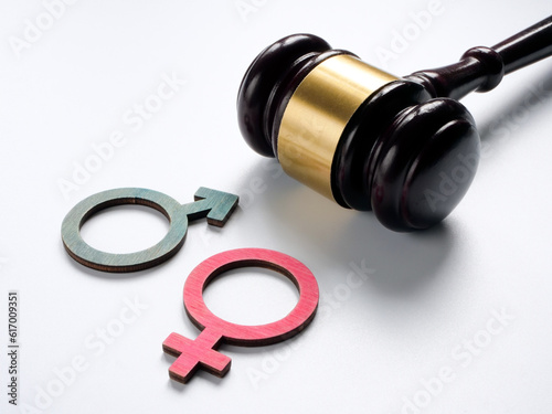 Gender discrimination concept. Male and female symbols near a gavel.