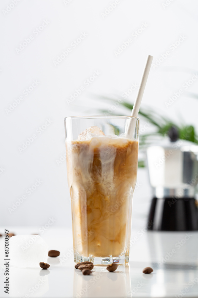 One iced coffee with paper straw with milk cold beverage One iced coffee with paper straw with milk cold beverage