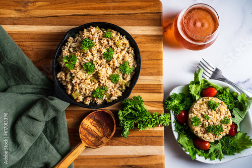 Dirty rice, a classic cajun dish made with ground pork, celery, onions, garlic scapes, and green pepper. Topped with parsley.