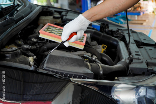 Wallpaper Mural Car mechanic using a screwdriver to tighten a screw car air filter Torontodigital.ca