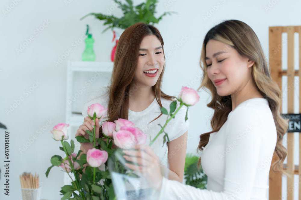 Beautiful asian woman giving bouquet of roses to her friend.