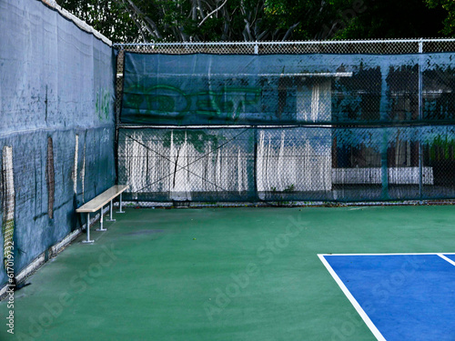 Empty tennis court with bench photo