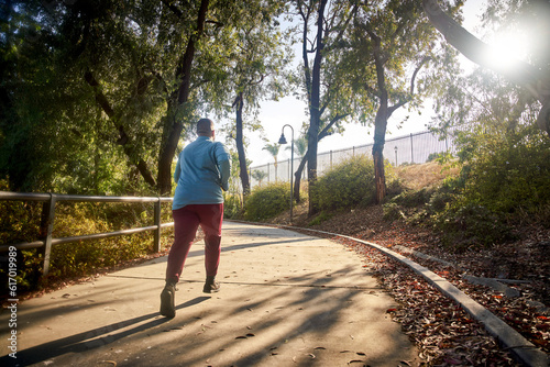Rear view of man jogging in park