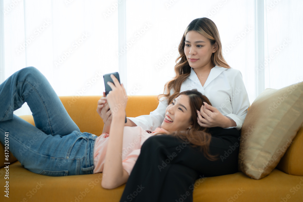 LGBT couple sitting on sofa and using laptop computer at home. LGBT couple sitting on sofa and using laptop computer at home.