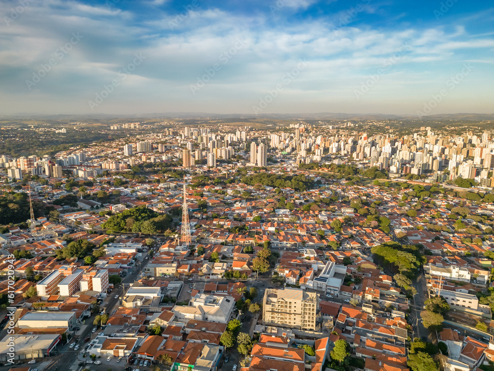 Fototapeta premium Campinas, Sao Paulo, Brazil. June 23, 2023. Aerial image of three central districts of Campinas: Vila Itapura, Cambuí and Jardim Guanabara. Sunset and blue sky.