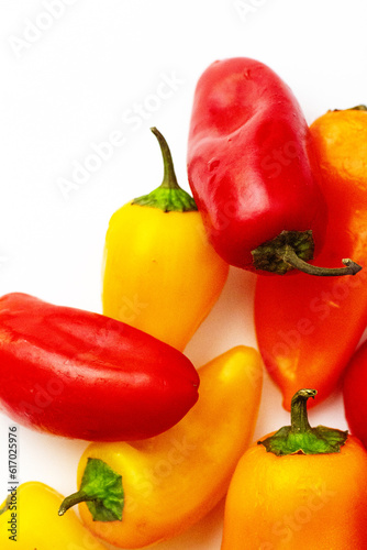 Fresh raw vegetables. Organic produce. Red and yellow peppers. Sweet pepper. White background. Above. Top view. Close up. Macro. Healthy eating. Vegetarian.