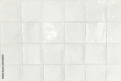 Modern white square tiles background. Installed modern rustic tiles wall close up in kitchen in new scandinavian house. Stylish minimal kitchen design. Tile pattern © sonyachny