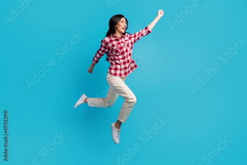 Full length body size view of her she nice attractive charming cheerful cheery girl jumping walking having fun isolated on blue color background
