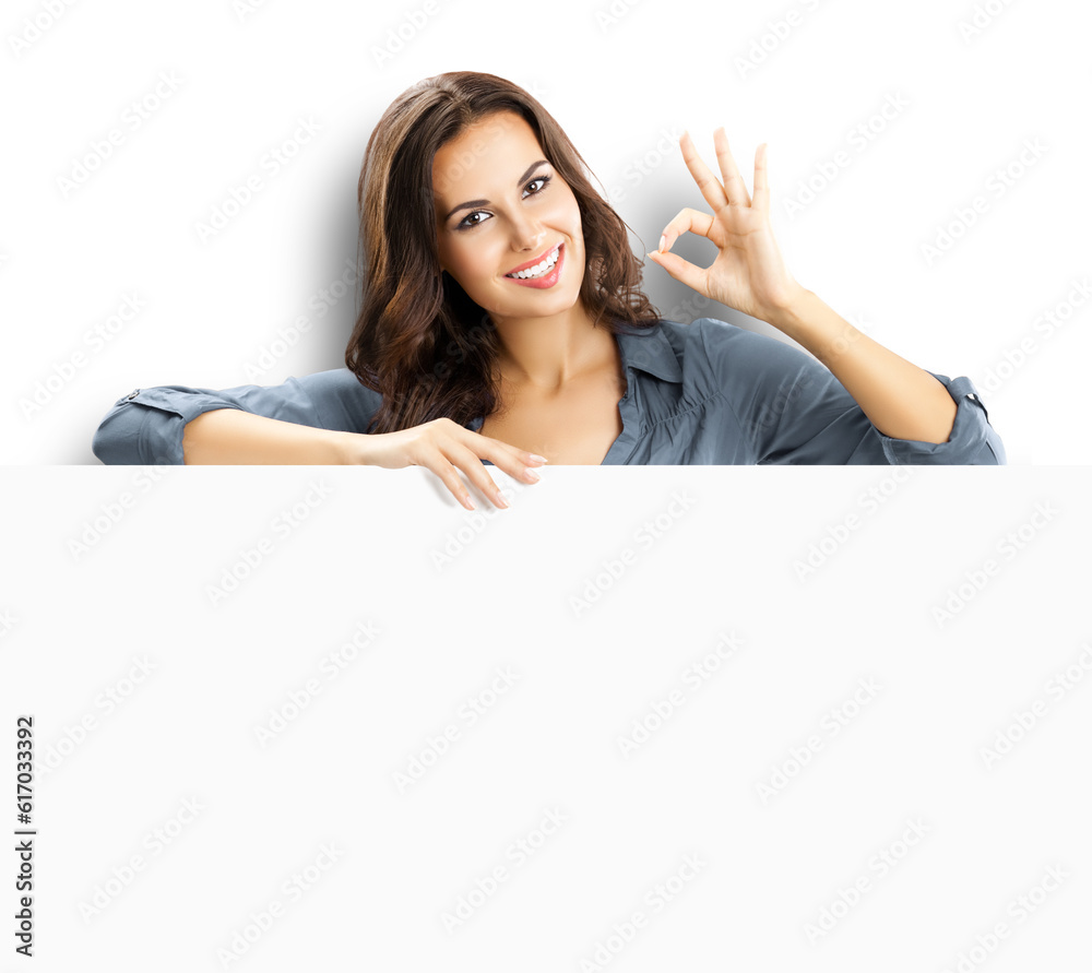 Beautiful woman stand beehind, peep out, hang over blank empty banner with copy space, isolated white background. Executive person, businesswoman, bank manager show ok okay hand sign gesture. Beautiful woman stand beehind, peep out, hang over blank empty banner with copy space, isolated white background. Executive person, businesswoman, bank manager show ok okay hand sign gesture.