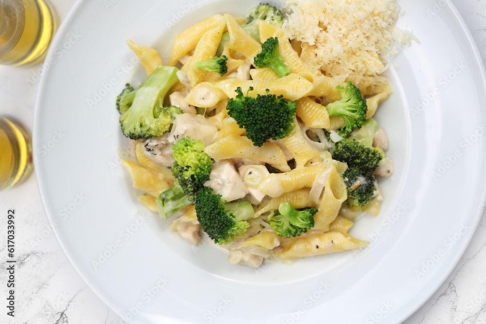 Pasta in a white sauce with broccoli and cheese. Penne, Italian dish with chicken, mediterranean cuisine, top view. Pasta in a white sauce with broccoli and cheese. Penne, Italian dish with chicken, mediterranean cuisine, top view.