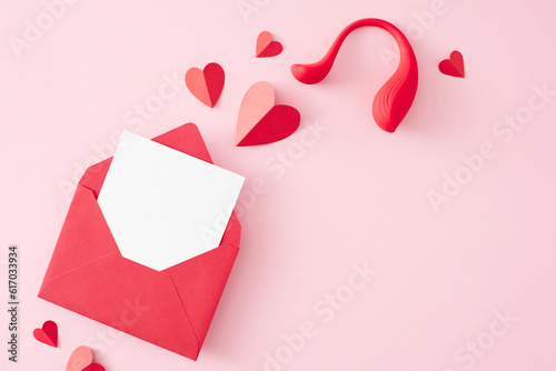 Embrace your sensuality with enticing adult toy. Top view photo of red vibrator, envelope with postcard, paper hearts on pastel pink background with empty space for text or promo