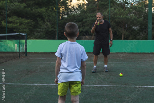 strict coach scolding his student during tennis practice © Mikhail