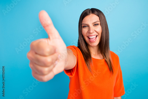 Young hispanic woman wearing casual clothes smiling happy and positive, thumb up doing excellent and approval sign © Tetiana