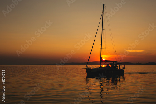 hajó és naplemente a Balatonon photo