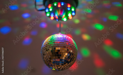 Disco ball system with reflecting lights in dark party nightclub interior.