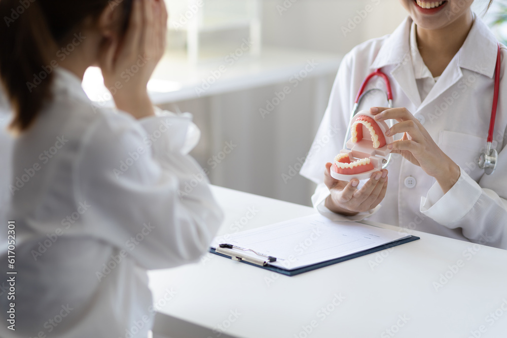 Patient with a toothache sees a dentist in a dental clinic at a hospital examination room. The doctor gives advice on maintaining oral health. Patient with a toothache sees a dentist in a dental clinic at a hospital examination room. The doctor gives advice on maintaining oral health.