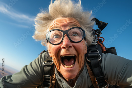 Happy mature woman having fun skydiving and enjoying summer. Action adventure for the second stage of life