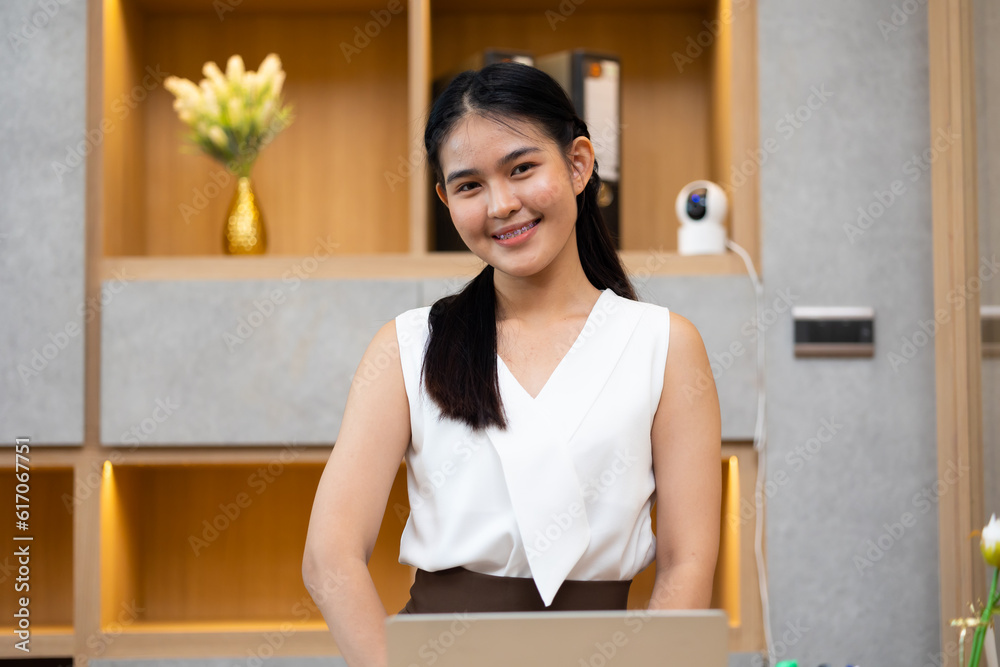 Young Asian woman. Portrait confident asian women smiling looking at camera at modern smallbusiness home office Young Asian woman. Portrait confident asian women smiling looking at camera at modern smallbusiness home office