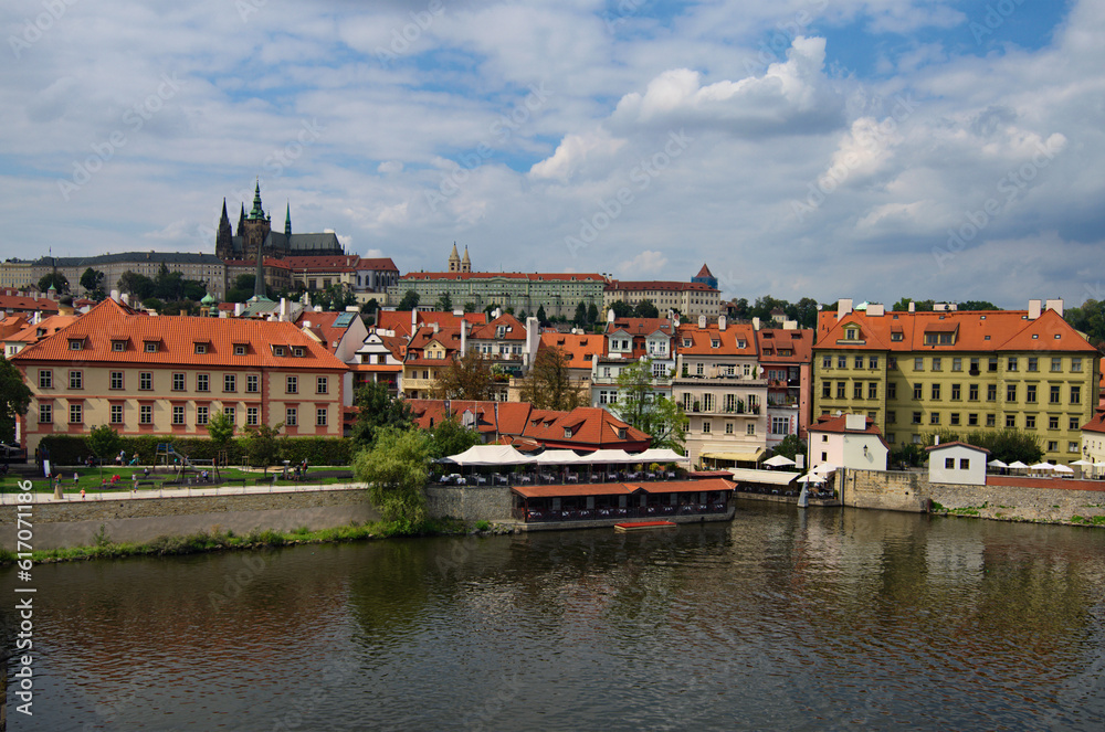 Beautiful cityscape view of the historical part of Prague. Famous Prague Castle with Saint Vitus Cathedral and typical historical buildings. Vltava River in the foreground. Prague, Czech Republic