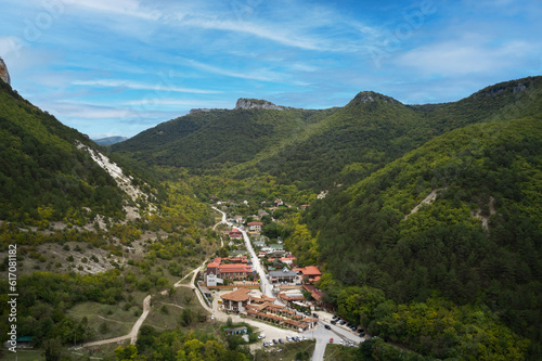 A picturesque aerial view of a mountain village near Lake Mangup in the Crimea. Shot from a drone.