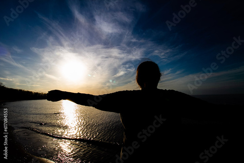 silhouette of a person standing on a rock