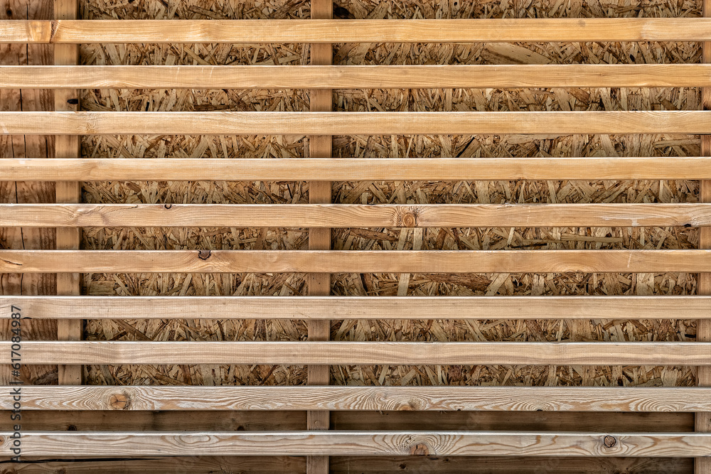 Wooden background with planks in the form of a decorative lattice. Wooden background with planks in the form of a decorative lattice.