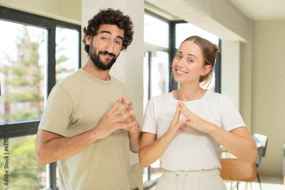 young adult couple scheming and conspiring, thinking devious tricks and cheats young adult couple scheming and conspiring, thinking devious tricks and cheats