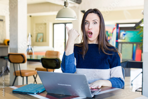 young pretty woman looking astonished in disbelief. telecommuting concept Free Download young pretty woman looking astonished in disbelief. telecommuting concept - GFXLoad