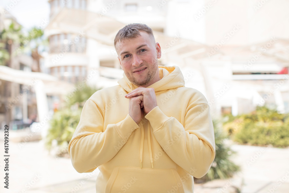 Naklejka premium handsome man happy and excited, surprised and amazed, giggling with a cute expression