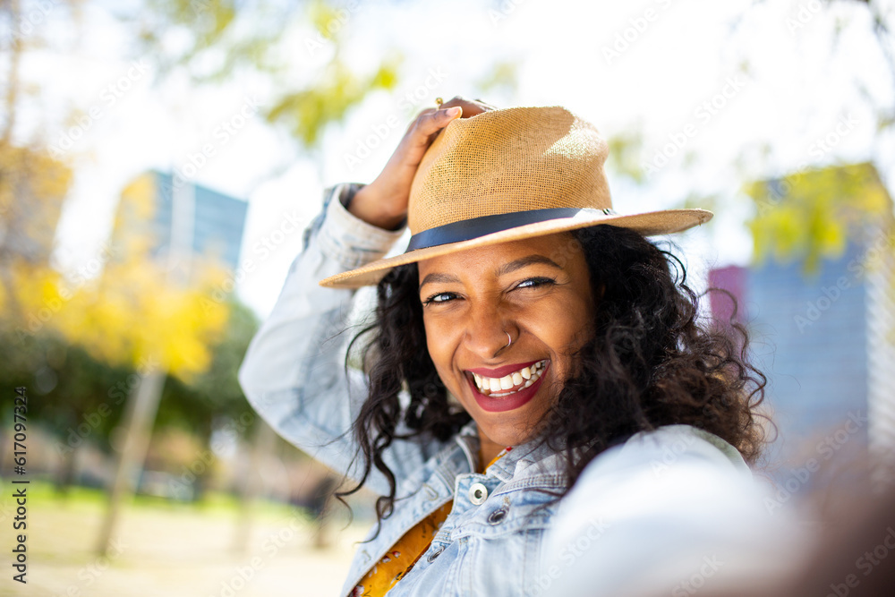 Selfie portrait of a beautiful african woman with hat