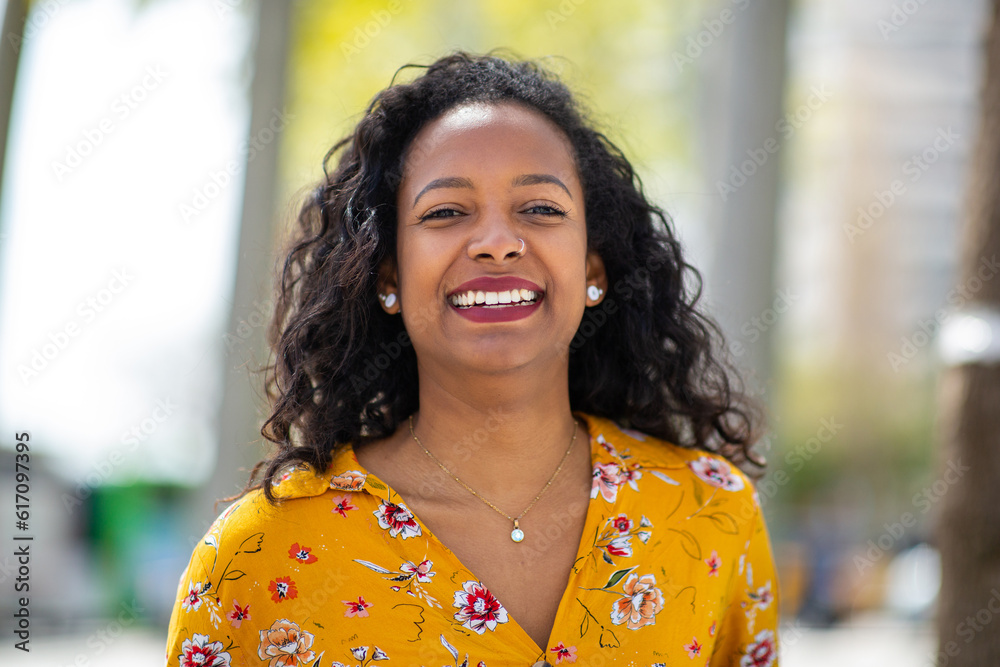 Portrait of beautiful young african woman smiling outside Portrait of beautiful young african woman smiling outside