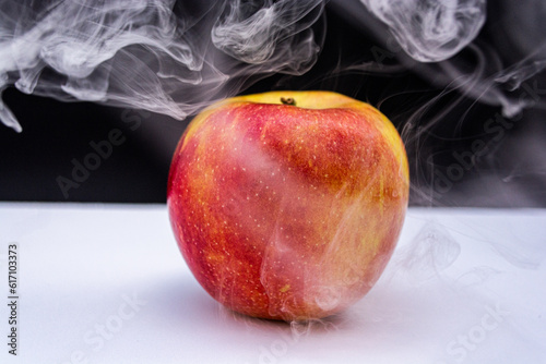 Apple with magical smoke, mystery apple on black and white