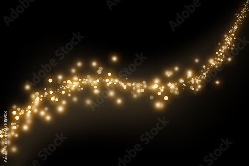 Wave of gold sparkles and glitter on black background. Abstract defocused lights and bokeh on dark background
