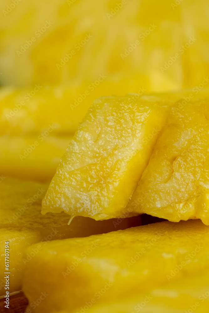 sliced ripe yellow pineapple, a large number of pieces sliced ripe yellow pineapple, a large number of pieces