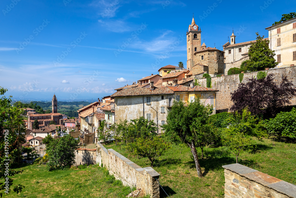 Small medieval town of Monforte d'Alba under blue sky in Italy.