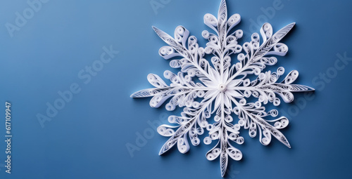 Banner of quilling with white snowflake closeup on blue background top view. Merry Christmas and Happy New Year holiday concept. Generative AI