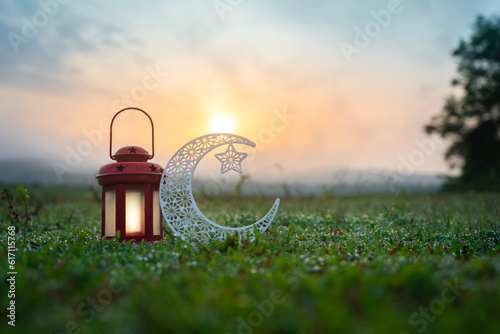 2023 Eid Al Adha greetings photography, Beautiful lantern lamp with half moon shape in the beach during sunrise