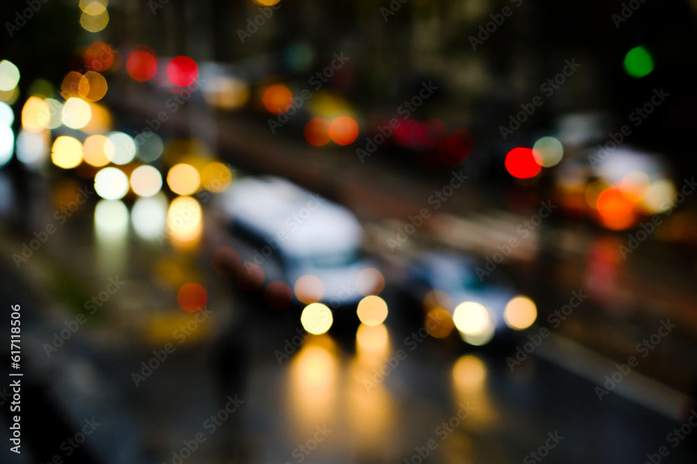 Blurry vehicles and bokeh lights on a road at night time in Istanbul. High-angle view of blurry traffic jam. Blurry vehicles and bokeh lights on a road at night time in Istanbul. High-angle view of blurry traffic jam.