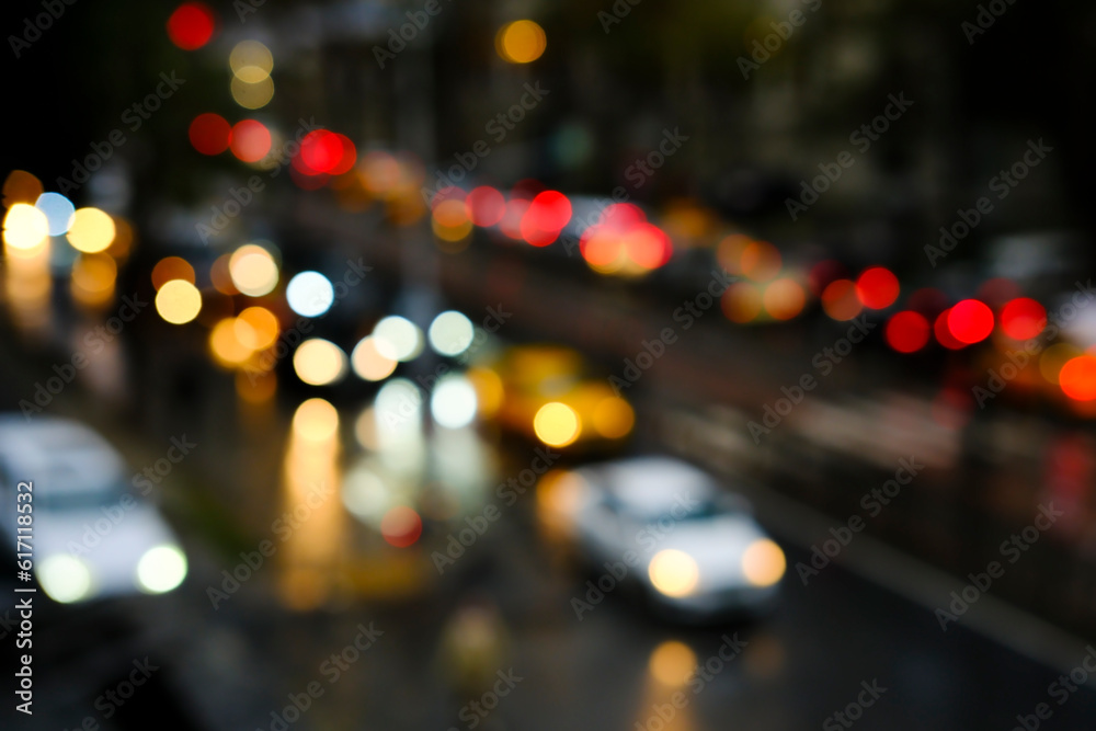 Blurry vehicles and bokeh lights on a road at night time in Istanbul. High-angle view of blurry traffic jam.